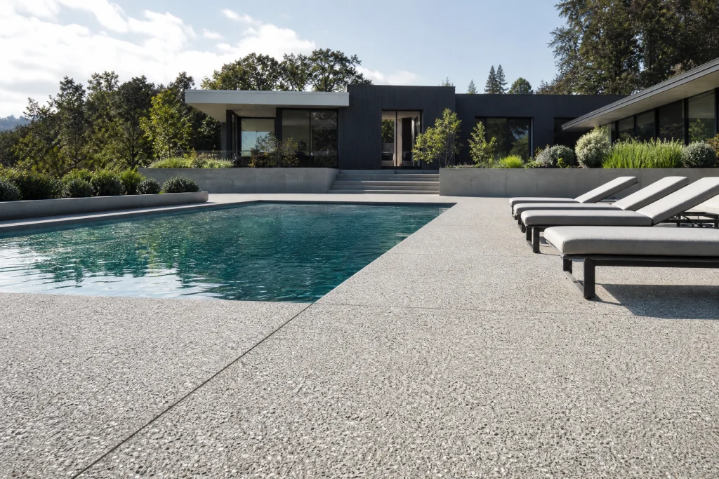 Exposed aggregate concrete poolside deck