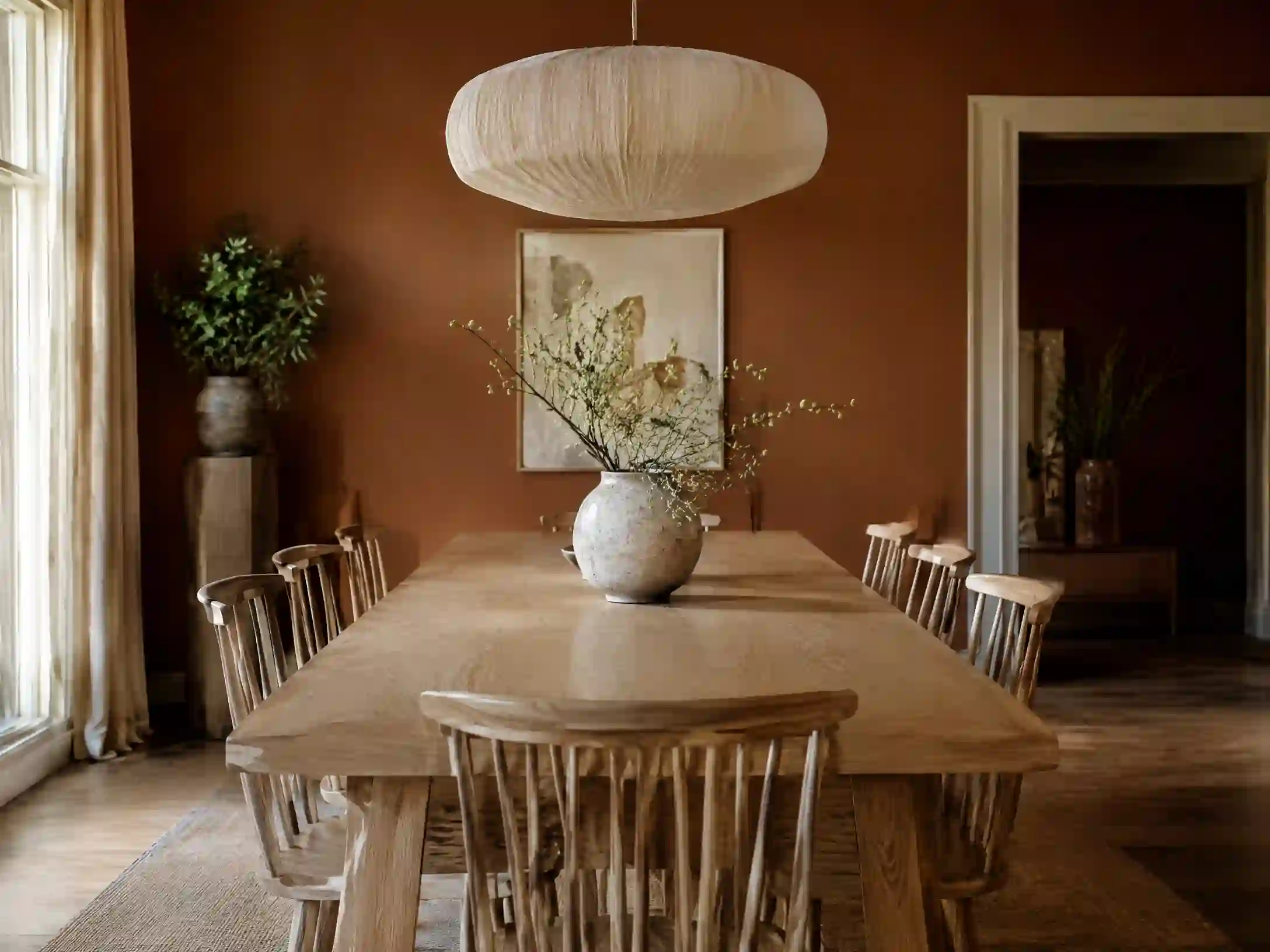 Terracotta, ivory, and honey wood Scandinavian dining space