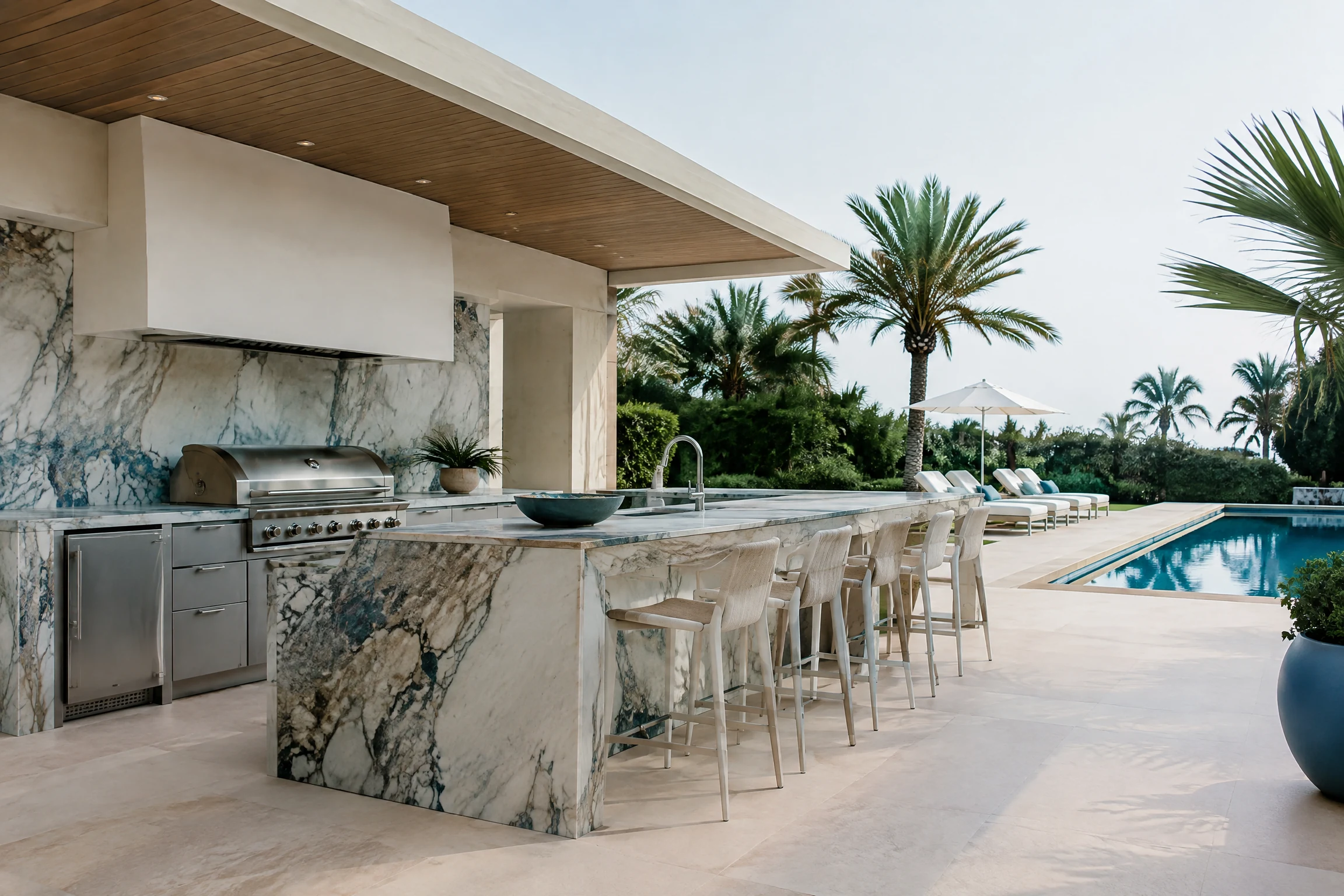 Luxury modern outdoor kitchen with marble island and pool deck